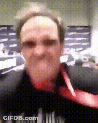 A Blurry Picture Of A Man Wearing A Black Shirt That Says ' A ' On The Front GIF