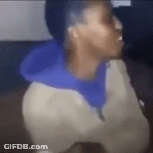A Blurry Picture Of A Man Wearing A Blue Hoodie And A White Jacket . GIF