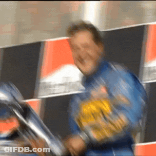 A Blurry Picture Of A Man Wearing A Blue Jacket With A Yellow Sticker On It GIF
