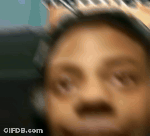 A Blurry Picture Of A Man Wearing A Crown On His Head GIF