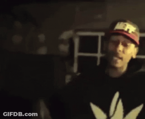 A Blurry Picture Of A Man Wearing A Hat And A Black Jacket . GIF