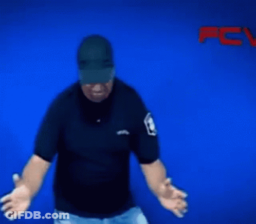 A Blurry Picture Of A Man Wearing A Hat And A Police Badge GIF