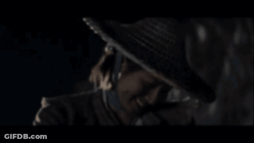 A Blurry Picture Of A Man Wearing A Hat GIF