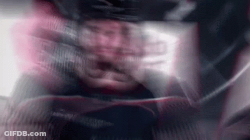 A Blurry Picture Of A Man Wearing A Helmet And A Jacket . GIF