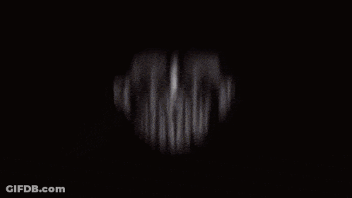 A Blurry Picture Of A Man Wearing A Red Shirt GIF