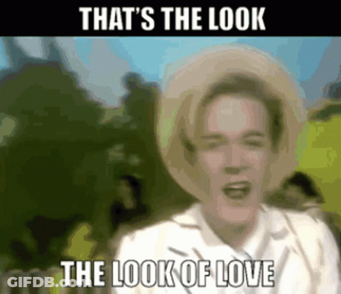 A Blurry Picture Of A Man Wearing A Straw Hat With The Words That 'S The Look The Look Of Love GIF
