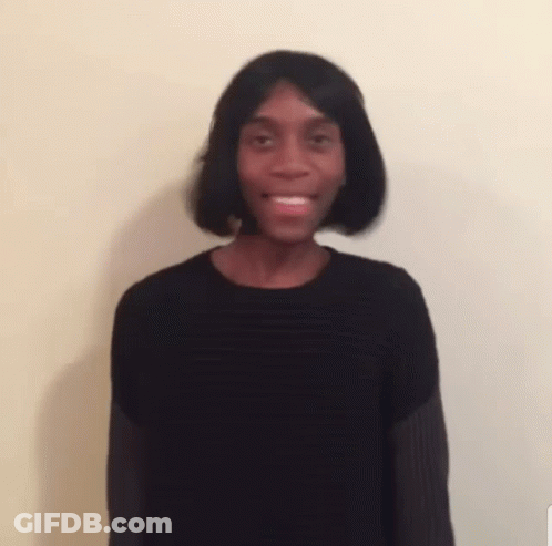 A Blurry Picture Of A Man Wearing A Wig And A Black Sweater . GIF