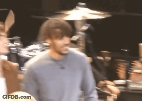 A Blurry Picture Of A Man Wearing Bunny Ears In Front Of A Drum Set GIF