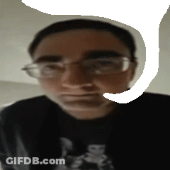 A Blurry Picture Of A Man Wearing Glasses And A Shirt That Says ' Doom ' On It GIF