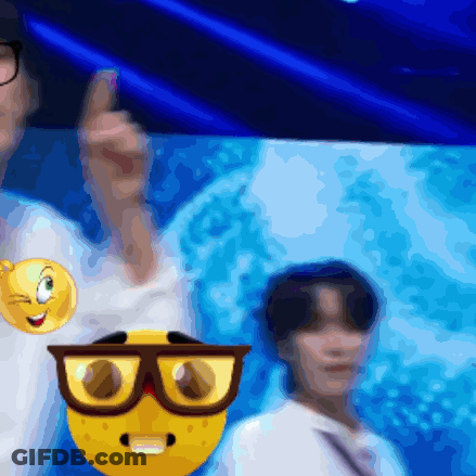 A Blurry Picture Of A Man Wearing Glasses And A Smiley Face On His Shirt GIF