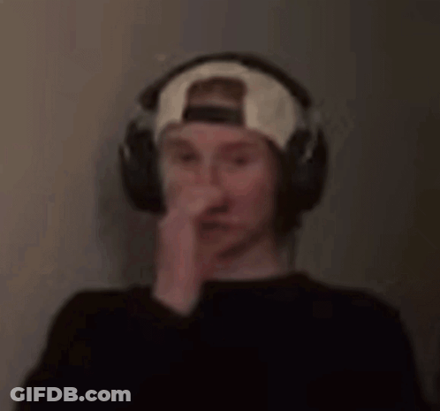 A Blurry Picture Of A Man Wearing Headphones And A Baseball Cap . GIF