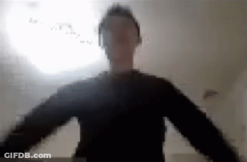 A Blurry Picture Of A Man Wearing Headphones And A Black Shirt . GIF