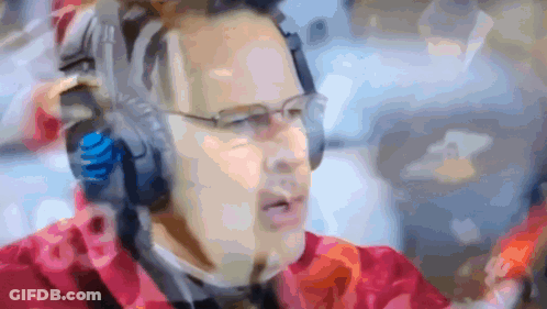 A Blurry Picture Of A Man Wearing Headphones And A Headset With The Number 18 On It GIF