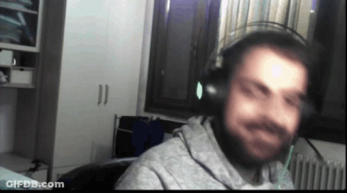 A Blurry Picture Of A Man Wearing Headphones In Front Of A Window GIF