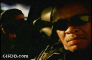 A Blurry Picture Of A Man Wearing Sunglasses And A Green Shirt GIF