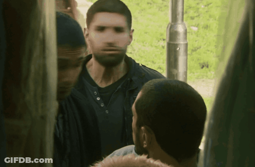 A Blurry Picture Of A Man With A Beard Standing Next To Another Man GIF