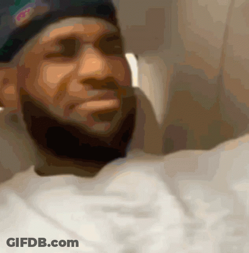 A Blurry Picture Of A Man With A Beard Wearing A Hat That Says ' Nba ' On It GIF
