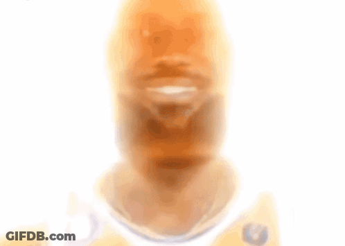 A Blurry Picture Of A Man With A Beard Wearing A White Jersey With A Eagle On It GIF
