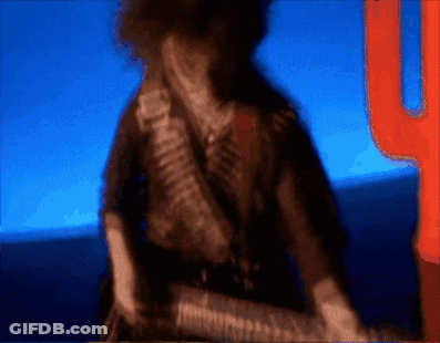 A Blurry Picture Of A Man With A Gun And A Cactus In The Background GIF