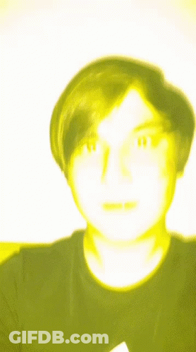 A Blurry Picture Of A Man With A Yellow Face GIF