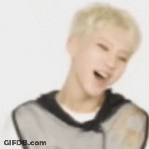 A Blurry Picture Of A Man With Blonde Hair Laughing . GIF