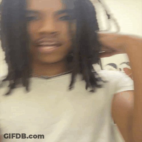 A Blurry Picture Of A Man With Dreadlocks GIF