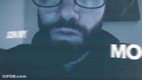 A Blurry Picture Of A Man With Glasses And The Word Mo Visible GIF