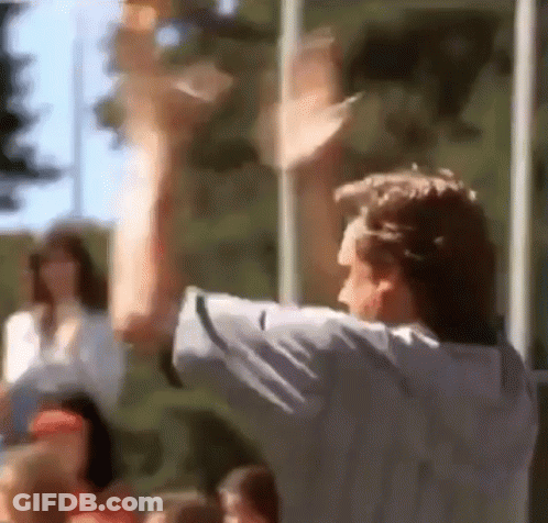 A Blurry Picture Of A Man With His Arms Up GIF