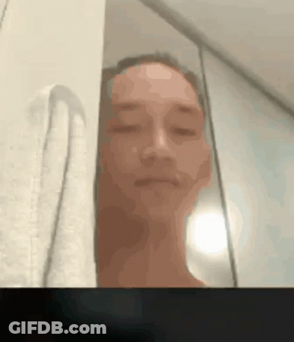 A Blurry Picture Of A Man With His Eyes Closed And A Towel Behind Him GIF