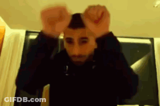 A Blurry Picture Of A Man With His Hands Up In The Air GIF