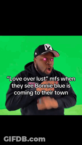 A Blurry Picture Of A Man With Pink Eyes And The Words " Love Over Lust " On His Face . GIF