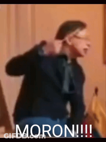 A Blurry Picture Of A Man With The Word Moron Written On The Bottom GIF