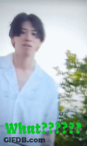 A Blurry Picture Of A Man With The Word What Written In Green GIF