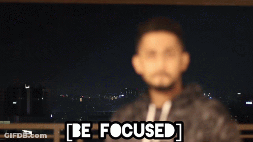 A Blurry Picture Of A Man With The Words Be Focused Written Above Him GIF