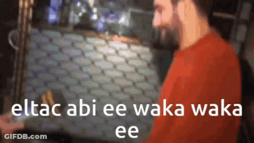 A Blurry Picture Of A Man With The Words Eltac Abi Ee Waka Waka Ee Written On It GIF