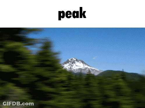 A Blurry Picture Of A Mountain And The Word Peak GIF