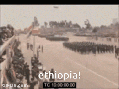 A Blurry Picture Of A Parade With The Words Ethiopia In The Upper Left Corner GIF