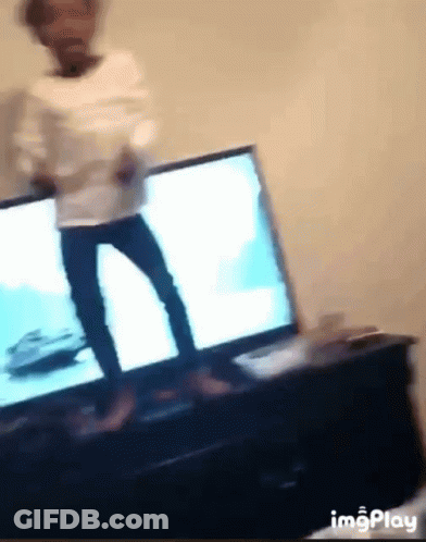 A Blurry Picture Of A Person Dancing In Front Of A Tv GIF