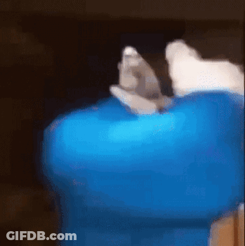 A Blurry Picture Of A Person Holding A Blue Item GIF