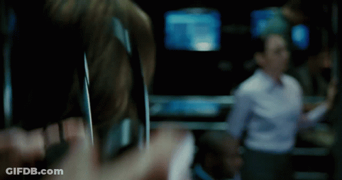 A Blurry Picture Of A Person Holding A Cell Phone In A Dark Room GIF