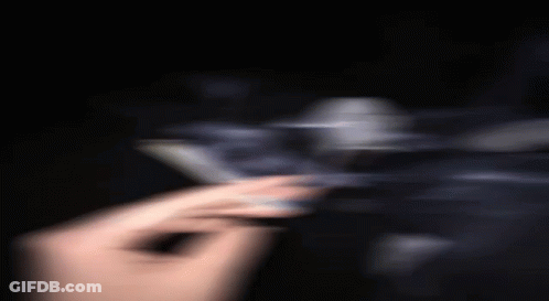 A Blurry Picture Of A Person Holding A Cigarette In Their Hand . GIF