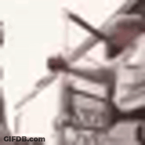 A Blurry Picture Of A Person Holding A Microphone In Their Hand . GIF