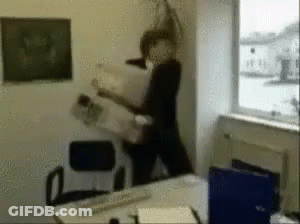 A Blurry Picture Of A Person Holding A Newspaper In An Office GIF
