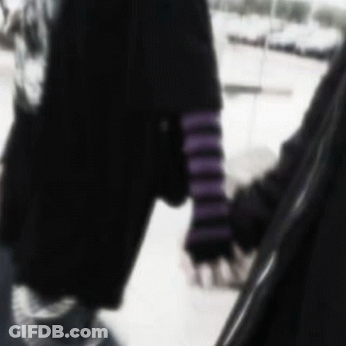 A Blurry Picture Of A Person Holding Another Person 'S Hand In The Snow . GIF