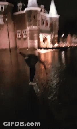 A Blurry Picture Of A Person In A Flooded Area At Night GIF