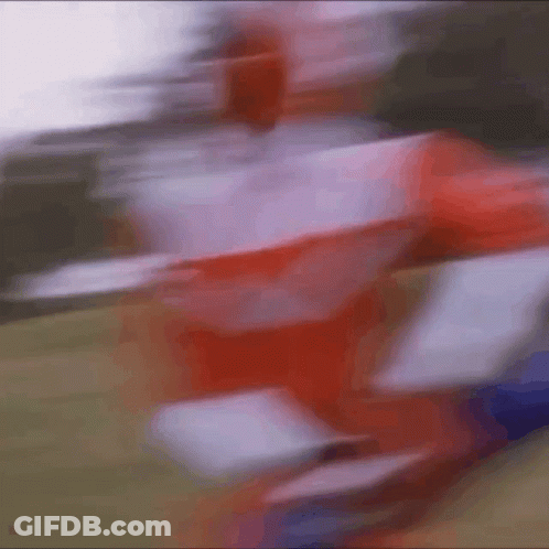 A Blurry Picture Of A Person In A Red And White Uniform GIF