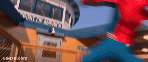 A Blurry Picture Of A Person Jumping In Front Of A Building That Says ' United States Of America ' GIF