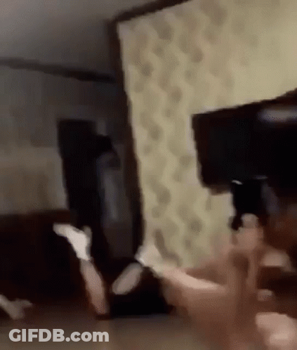 A Blurry Picture Of A Person Laying On The Floor In A Room . GIF