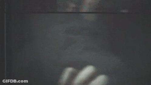A Blurry Picture Of A Person Looking Out Of A Window GIF