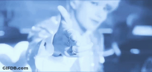 A Blurry Picture Of A Person Pointing Their Finger At The Camera GIF